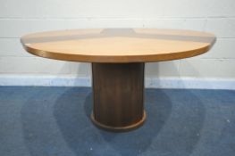 A SKOVBY OF DENMARK CIRCULAR DINING TABLE, with a winding mechanism revealing three additional