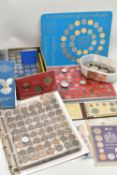 A BOX CONTAINING TWO ALBUMS OF BRITISH COINS, A LINDNER TRAY OF MAINLY WORLD COINS OF WHICH ARE