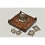 AN INKWELL AND TWO NURSES BELT BUCKLES, a glass and white metal inkwell together with an oak,