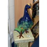 A CERAMIC ART NOUVEAU PEACOCK ON MATCHING PEDESTAL BASE, height 108cm to top of peacock (1) (