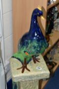 A CERAMIC ART NOUVEAU PEACOCK ON MATCHING PEDESTAL BASE, height 108cm to top of peacock (1) (