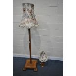 A BESPOKE OAK STANDARD LAMP, of a square form, height 161cm, with a floral fabric shade, along