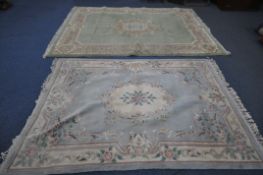 A LARGE GREEN CHINESE RUG, 306cm x 213cm, along with a smaller blue Chinese rug (condition
