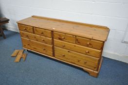 A MODERN DUCAL PINE SIDEBOARD/CHEST OF EIGHT DRAWERS, on casters, width 170cm x depth 48cm x