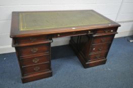 A MAHOGANY PEDESTAL DESK, with a green leather writing surface, and nine drawers, width 142cm x