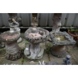 THREE LOW WEATHERED COMPOSITE BIRD BATHS, of various styles, largest bird bath measurement, 32cm x