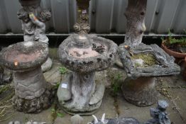 THREE LOW WEATHERED COMPOSITE BIRD BATHS, of various styles, largest bird bath measurement, 32cm x