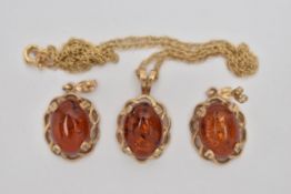 A PAIR OF COPAL AMBER EARRINGS AND A PENDANT, oval cabochon copal amber set in an open work yellow