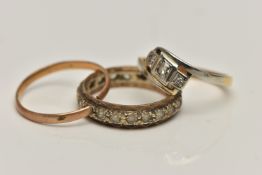 THREE RINGS, the first a three stone yellow and white metal cross over ring, set with a central