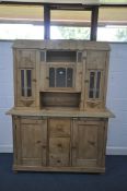 A VICTORIAN PINE CONTINENTAL DRESSER, the top with an arrangement of glazed cupboard doors, over a