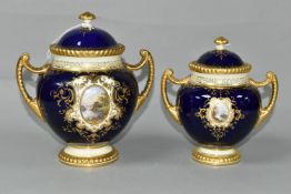 TWO EARLY 20TH CENTURY COALPORT TWIN HANDLED VASES AND COVERS, blue, pale yellow and gilt ground,