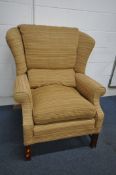 A STRIPPED UPHOLSTERED WING BACK ARMCHAIR, on wooden legs, width 84cm x depth 100cm x height