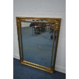 A LARGE GILT FRAME FRAMED WALL MIRROR, with foliate decoration and a mirrored frame, 122cm x 93cm (