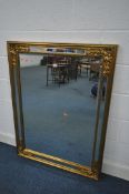 A LARGE GILT FRAME FRAMED WALL MIRROR, with foliate decoration and a mirrored frame, 122cm x 93cm (