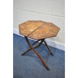 AN EARLY 20TH CENTURY CARVED OAK FOLDING CAMPAIGN TABLE, diameter 52cm x height 54cm (condition