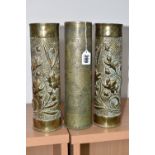THREE TRENCH ART VASES, comprising a pair of vases decorated with flowers on a punched background,
