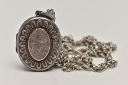 A LATE VICTORIAN SILVER LOCKET, oval form etched floral centre with embossed detail surround, fitted