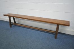 A 20TH CENTURY OAK BENCH, on chamfered trestle legs united by a single stretcher, length