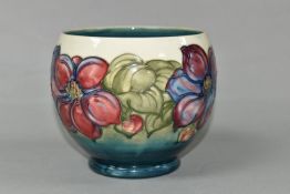 A MOORCROFT POTTERY PLANTER, of rounded form, tube lined with a pink and purple Clematis pattern
