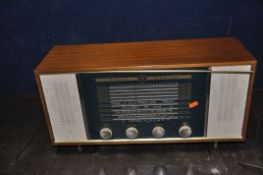 A VINTAGE EKCO ZODIAK VALVE RADIO in a walnut case (PAT fail due to uninsulated plug powers up and