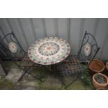 A CIRCULAR WEATHERED METAL TILE TOP FOLDING GARDEN TABLE, and two chairs (condition report: -seat