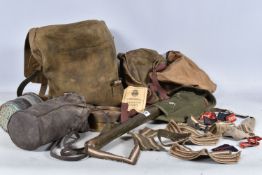 A QUANTITY OF MILITARY RELATED ITEMS, to include bags, gas mask, entrenching tool and a pressure