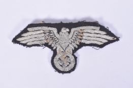 A THIRD REICH GERMANY SS OFFICERS TUNIC SLEEVE EAGLE, this is hand embroidered with silver