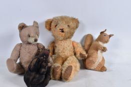 A WELL LOVED GOLDEN PLUSH TEDDY BEAR, original amber and black plastic eyes, remains of vertical