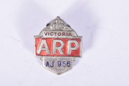 A WWIIERA AUSTRALIAN ARP BADGE, this is white metal and red, issues by the state of Victoria and has