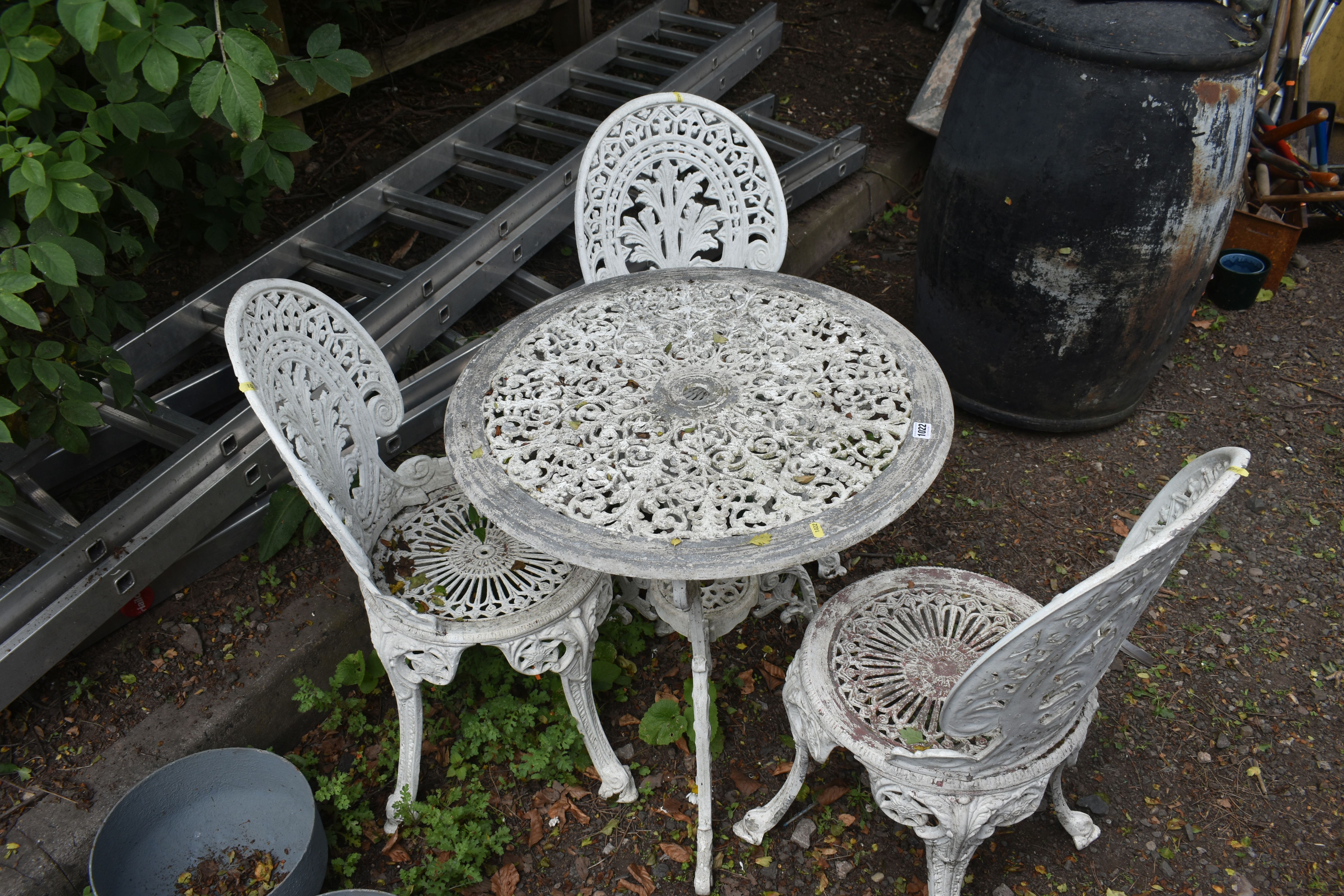 A WHITE PAINTED ALUMINIUM GARDEN BISTRO SET, comprising a circular table, with pierced foliate - Image 2 of 2