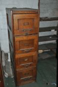 AN EARLY 29th CENTURY OAK FILING CABINET with four drawers, brass handles and card holders, panelled