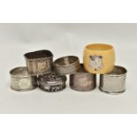 AN ASSORTMENT OF SILVER AND WHITE METAL NAPKIN RINGS, five silver napkin rings varying in design,