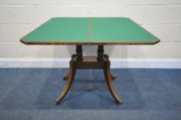 A DISTRESSED GEORGIAN WALNUT FOLD OVER GAMES TABLE, on twin turned supports, on splayed legs and