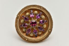 A YELLOW METAL ETRUSCAN GARNET BROOCH, of a domed circular form, set with circular and oval cut