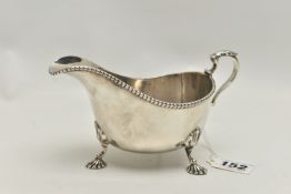 A SILVER 'SELFRIDGE & CO' SAUCE BOAT, decorated with three scalloped feet, acanthus handle and