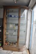 A VICTORIAN SHOP DISPLAY CABINET with quarter round glazed end, straight glass door and flat