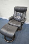 A BROWN LEATHER STRESSLESS STYLE RECLINING SWIVEL CHAIR, and footstool (condition: -loose