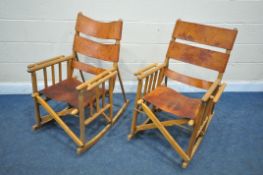 A PAIR OF MID CENTURY COSTA RICAN BEECH FRAMED AND LEATHER STRAPPED FOLDING ROCKING CHAIRS (