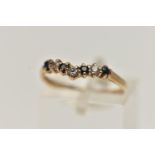 A 9CT GOLD SAPPHIRE AND CUBIC ZIRCONIA WISH BONE RING, alternating blue sapphires and colourless