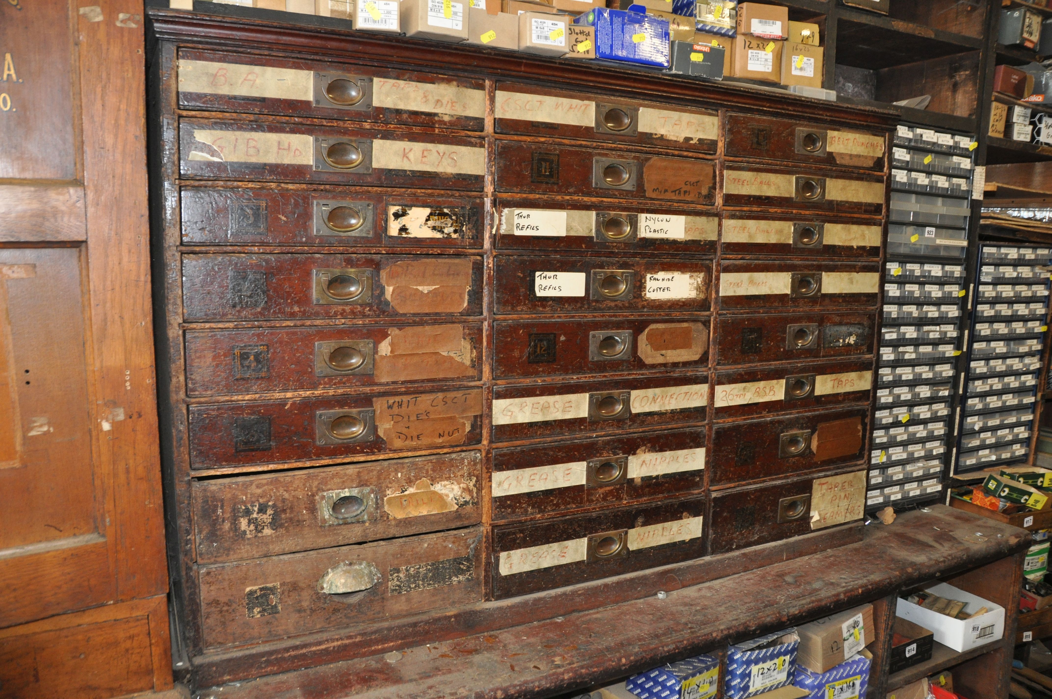 AN EDWARDIAN MAHOGANY HARBERDASHERS CHEST OF TWENTY FOUR DRAWERS with campaign handles to all but