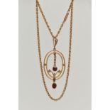A YELLOW METAL LAVALIER PENDANT AND CHAIN, oval openwork pendant set with garnets and split