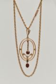 A YELLOW METAL LAVALIER PENDANT AND CHAIN, oval openwork pendant set with garnets and split