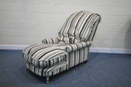 AN EARLY 20TH CENTURY DEEP SEATED ARMCHAIR, with stripped upholstery and studded detailing, width