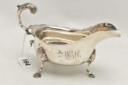 A LATE VICTORIAN SILVER GRAVY BOAT, polished form with engraved monogram and dated 1934-1959, wavy