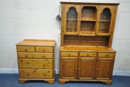 A DUCAL PINE DRESSER, the top with two glazed doors, flanking a central shelving section, the base