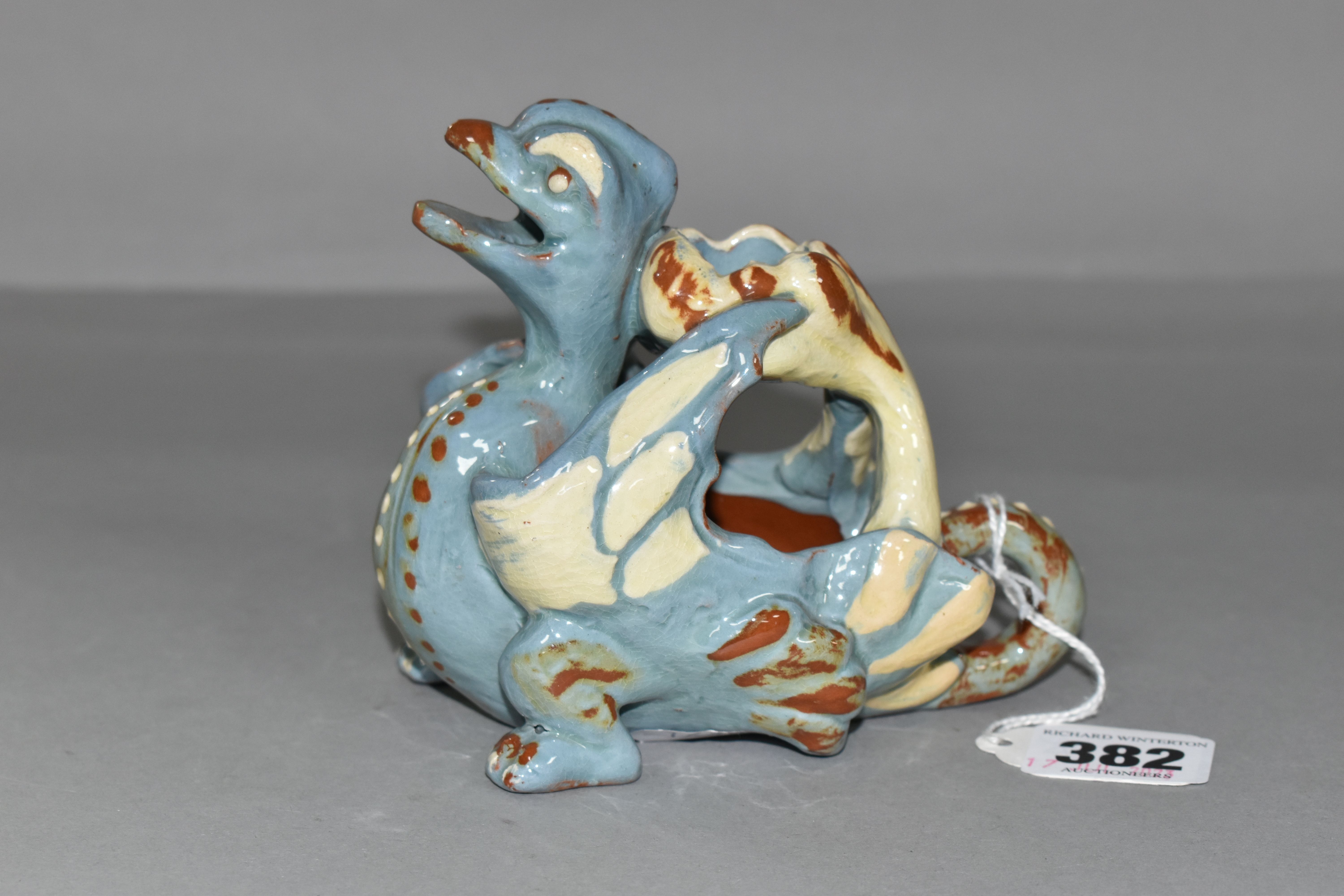 A C.H BRANNAN POTTERY 'GRIFFIN' CANDLE/SPILL HOLDER, incised CH Brannam, Barum, dated 1894, slip