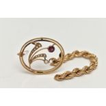 A YELLOW METAL GARNET AND SPLIT PEARL BROOCH, of an oval open work form, flower set with a