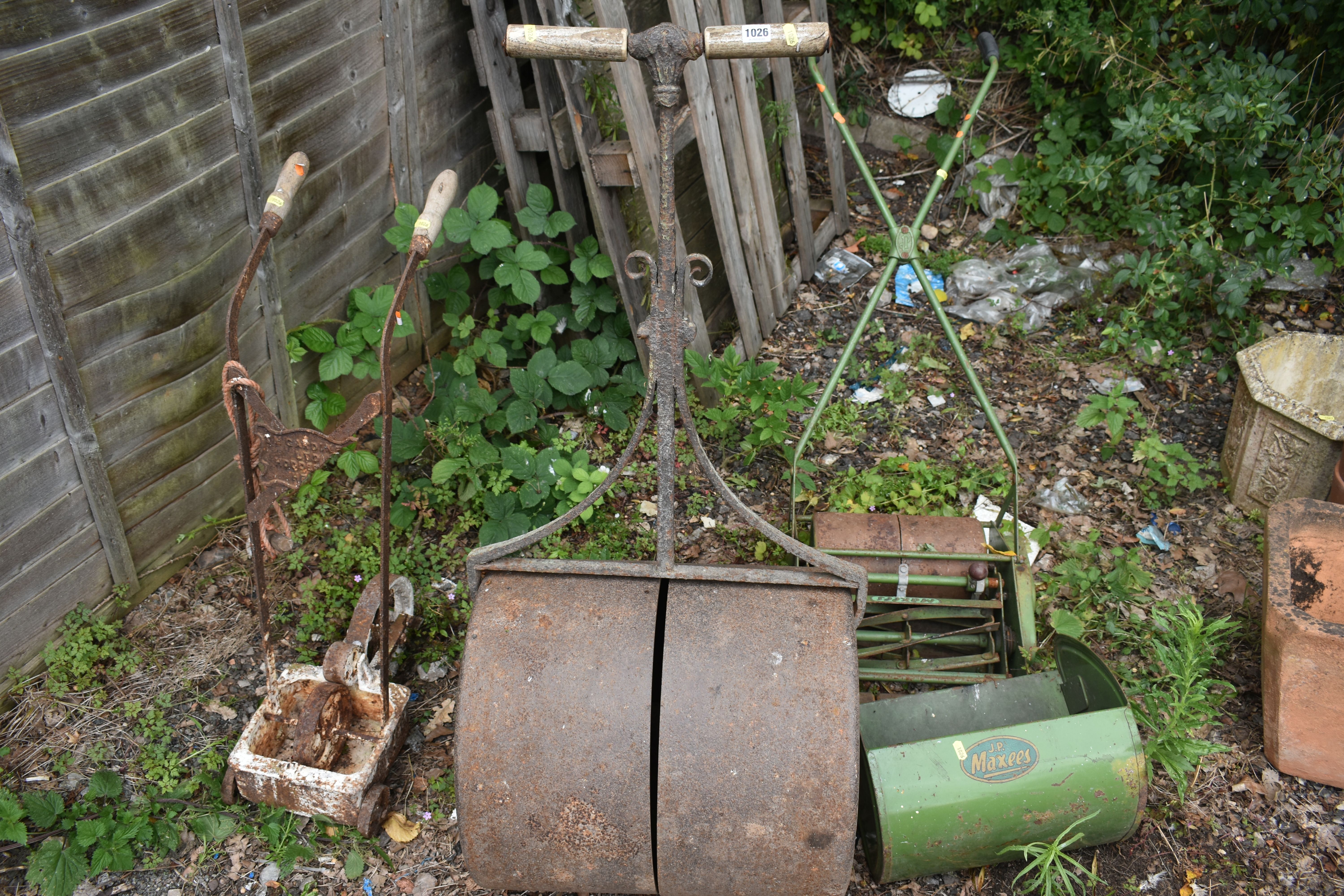 A VINTAGE CAST IRON GARDEN ROLLER, a vintage line marker, labelled 'TM GARDINE' and J P Maxees