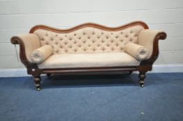 A VICTORIAN WALNUT THREE SEATER SOFA, with a shaped back, scrolled armrests, on turned legs and