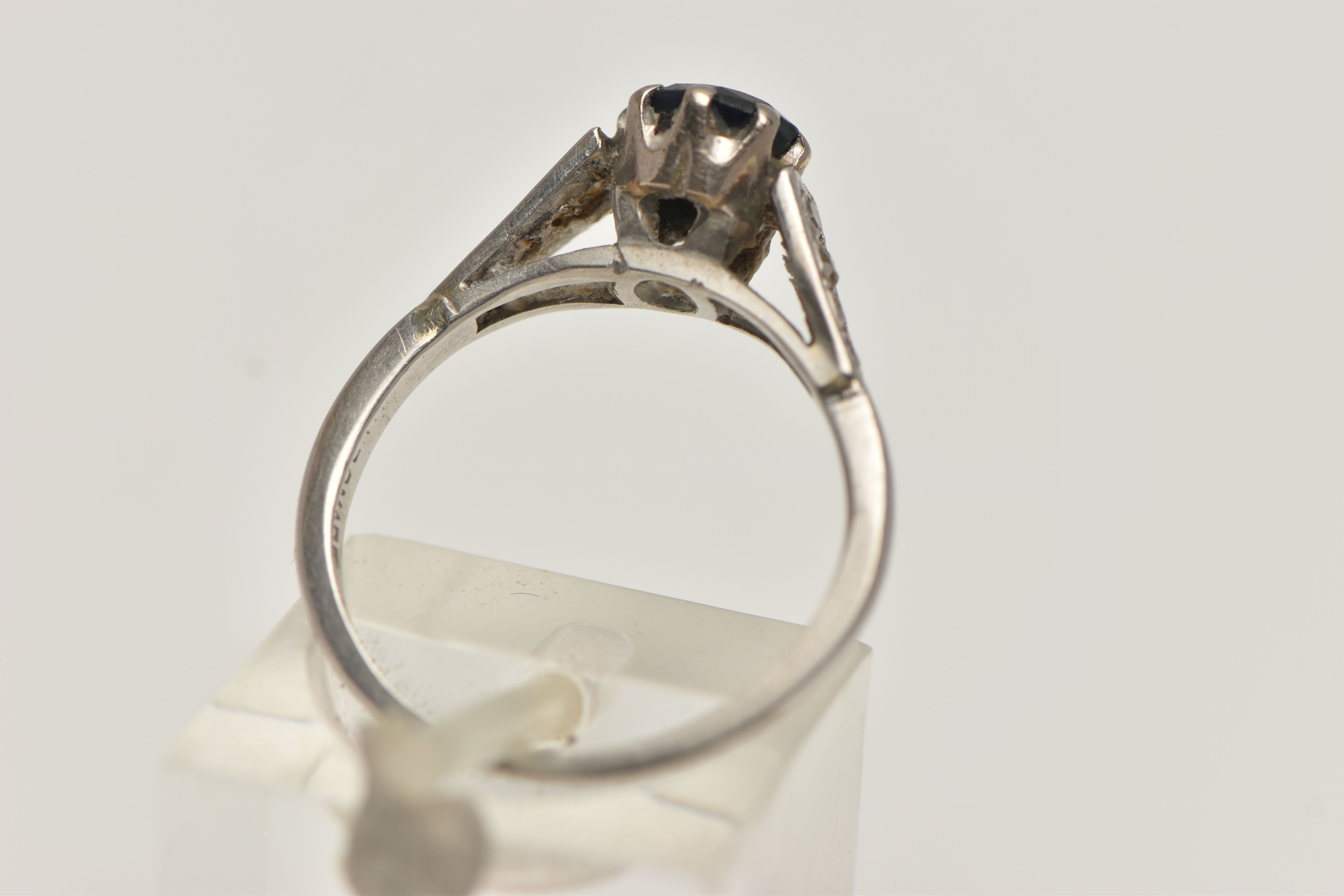 A WHITE METAL GEM SET RING, a circular cut sapphire in a prong setting, leading on to tapered - Image 3 of 4